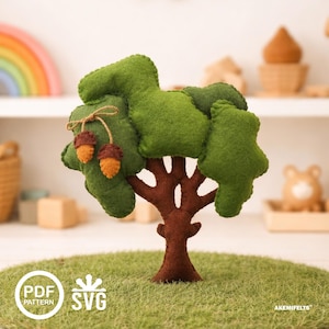 May include: A handcrafted felt tree with a brown trunk, green leaves, and two hanging acorns. The tree is set on a green surface, with "PDF PATTERN" and "SVG" icons in the lower left corner. The tree is a decorative item.