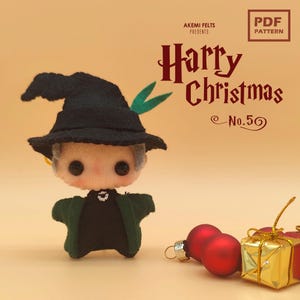 May include: A felt doll of a character wearing a black hat and green coat, with the text "Harry Christmas" and "No. 5" in a festive font. Red ornaments and a gold gift box are in the foreground. The doll is a handmade craft.