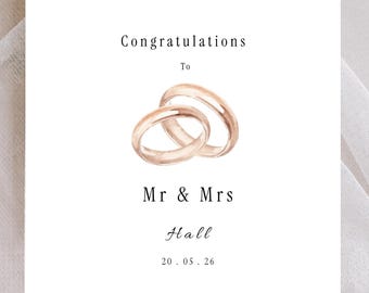 Tarjeta de felicitación de boda personalizada, anillos de oro rosa, diseño minimalista, nombres y fecha personalizados.