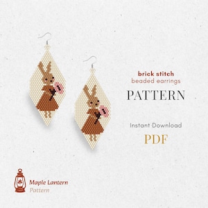 May include: Two diamond-shaped beaded earrings, each with a brown bunny holding a pink flower. The earrings are cream-coloured, with the text "brick stitch beaded earrings PATTERN" and "Instant Download PDF".