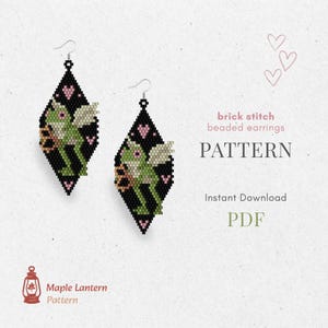 May include: Black beaded earrings with a diamond shape, featuring a green frog design with wings and pink hearts. The text on the image says "brick stitch beaded earrings PATTERN Instant Download PDF". The earrings are from Maple Lantern Pattern.