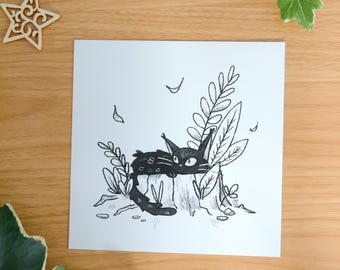 May include: A square white art print featuring a black ink illustration of a cat resting on a tree stump surrounded by foliage. The cat has large eyes and tufted ears. The text "by mossyleaf studio" is printed in small white letters at the bottom.
