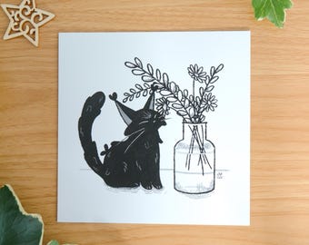 May include: A square art print featuring a black cat with tufted ears sitting next to a clear glass vase filled with a bouquet of line-drawn flowers. The illustration is rendered in black ink on a white background with the text mossyleaf studio.