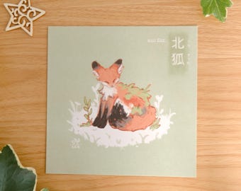 May include: A square art print on a sage green background featuring an illustration of a small orange and white fox with dark markings. The fox is surrounded by white stylized foliage. The text "eco fox" and Japanese characters are visible.