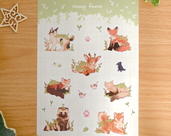 May include: A rectangular sticker sheet titled mossy fauna featuring various illustrated animals including a calico cat, a fox, a deer, a raccoon, and a small bird, all adorned with green moss accents on a light green grid background.