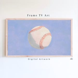 May include: A digital artwork of a baseball in a light blue background, framed in a light wood frame. The baseball is white with red stitching. The text "Frame TV Art" and "Digital Artwork" are visible.