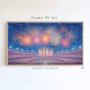 May include: A framed digital artwork showing a fireworks display over a stadium at night. The artwork features vibrant orange, yellow, and pink fireworks against a dark blue sky. Text on the artwork reads "Frame TV Art" and "Digital Artwork".