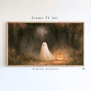 May include: A rectangular digital artwork titled Frame TV Art featuring a white ghost standing in a dark, misty forest at night next to a glowing orange jack-o'-lantern with a crescent moon visible in the sky above the trees.