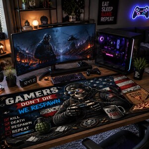 May include: A gaming setup featuring a curved monitor displaying a war scene, a desktop computer, and a large mousepad. The mousepad has an American flag design with a skull wearing sunglasses and the text "GAMERS DON'T DIE WE RESPAWN."