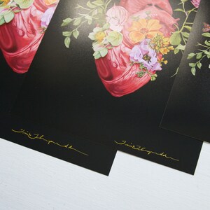May include: Three black and white prints of a red anatomical heart with floral accents. The prints are signed "Jimi Thompson" in gold lettering.
