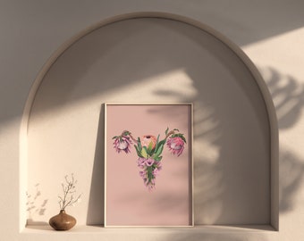 May include: A framed print with a pink background featuring a stylized floral arrangement in the shape of a human reproductive organ. The flowers are pink, white, and green.