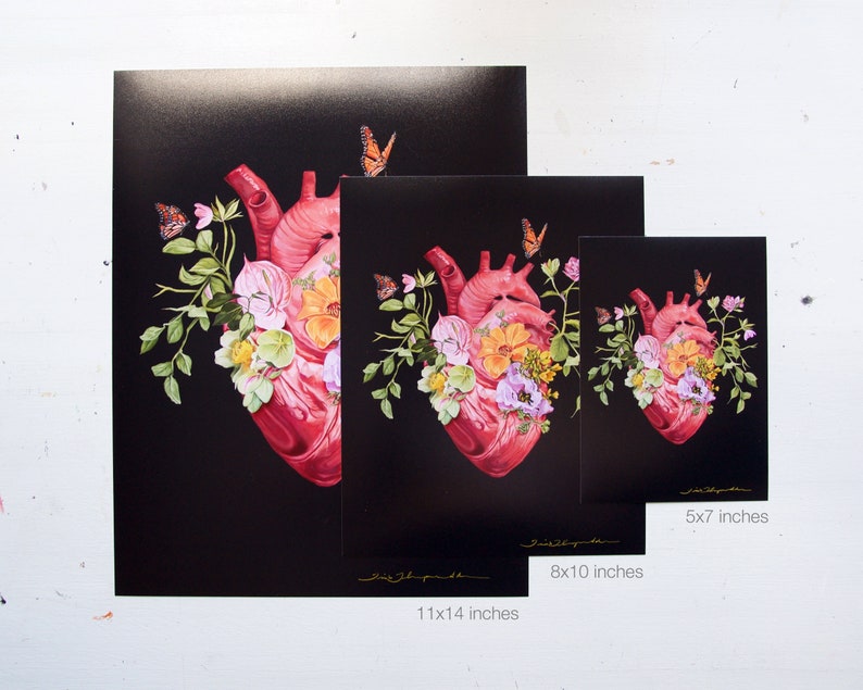 May include: A digital art print featuring a human heart adorned with flowers and butterflies. The heart is red, while the flowers are pink, yellow, and white. The butterflies are orange and black. The print is available in three sizes: 5x7 inches, 8x10 inches, and 11x14 inches.