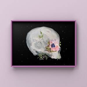 May include: A white skull with a pink flower growing out of its eye socket against a black background with white stars.