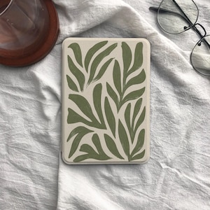 May include: A rectangular e-reader case featuring a cream-colored background with a repeating pattern of hand-painted style olive green leaves. The case has rounded corners and a smooth finish, displaying a botanical design across the entire front surface.