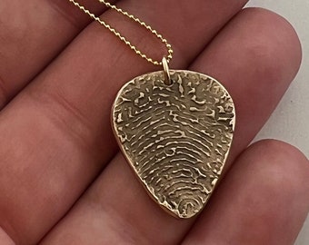 Guitarpick fingerprint or thumbprint in bronze and gold