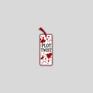 May include: A rectangular bookmark with the words "PLOT TWIST" in black text. The bookmark has a white background with red splatter designs. A red ribbon is attached at the top.