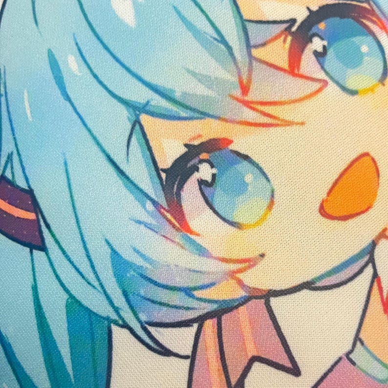May include: Close-up of a colorful anime-style illustration. The image features a character with light blue hair, large blue eyes, and a peach-colored cheek. The artwork has a soft, pastel color palette.