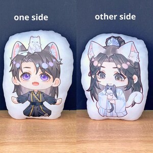 May include: Two white plush pillows with anime-style illustrations. One side features a character with purple eyes, cat ears, and a small white cat. The other side shows a similar character holding a gray cat. Text on top says "one side" and "other side".