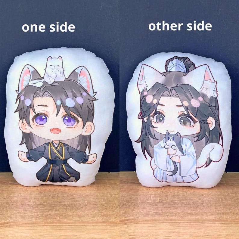 May include: Two white plush pillows with anime-style illustrations. One side features a character with purple eyes, cat ears, and a small white cat. The other side shows a similar character holding a gray cat. Text on top says "one side" and "other side".
