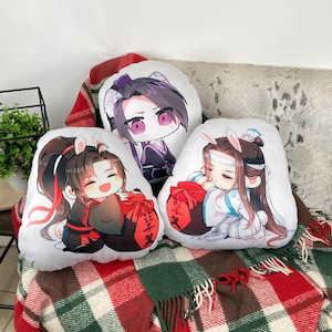 May include: Three white decorative pillows with anime-style illustrations. Each pillow features a different character with bunny ears, holding a red bag. The characters are dressed in various outfits, with black, red, and white color schemes.