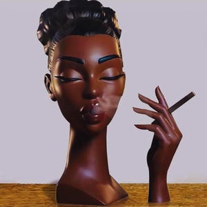 May include: A dark brown sculpture of a woman's head and hand. The head has closed eyes and is exhaling smoke. The hand is holding a dark brown cigar. The sculpture has a glossy finish and is set against a neutral background.