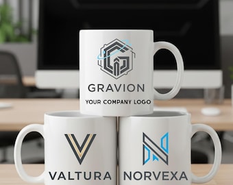 May include: Three white ceramic mugs stacked on a wooden surface. The top mug features the word "GRAVION" and "YOUR COMPANY LOGO" in black text, with a geometric design. The bottom mugs display the names "VALTURA" and "NORVEXA" with their respective logos.