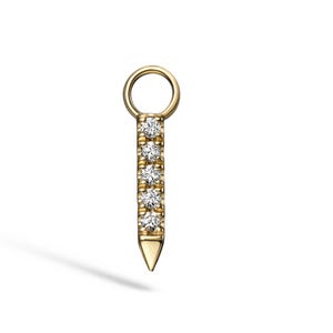 May include: A gold-colored pendant with a small loop at the top and a pointed bottom. The pendant is adorned with a vertical row of five small, sparkling diamonds. The jewelry piece is set against a white background.