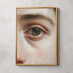 Puede incluir: Pintura al óleo enmarcada que presenta un primer plano de un ojo humano. El ojo es marrón, con pinceladas detalladas y un marco dorado. Los tonos de piel son pálidos con toques de rosa y marrón.
