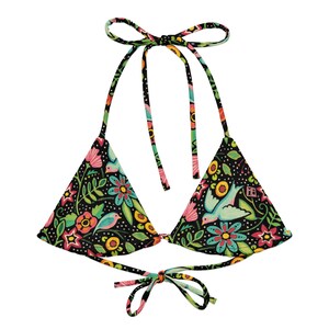 May include: A black halter bikini top with a colorful floral and bird pattern. The top features a triangle shape with tie closures at the neck and back. The design includes pink, yellow, and blue flowers and birds.