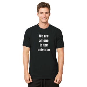 May include: Black crew neck t-shirt with the white text "We are all one in the universe". The shirt is made of a soft material and is suitable for casual wear.