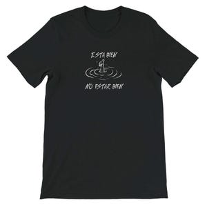 May include: Black t-shirt with white text and a simple illustration. The text reads "ESTA BIEN" above a drawing of a person in water, with the words "NO ESTAR BIEN" below. The design is a humorous take on feeling okay versus not okay.