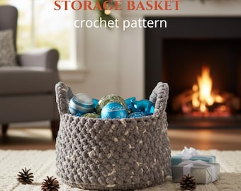 May include: A gray crochet storage basket filled with blue and white ornaments. The basket has two handles and is sitting on a cream-colored rug. The text "STORAGE BASKET crochet pattern" is at the top of the image.