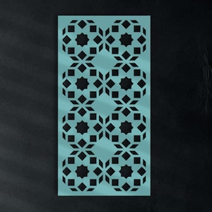 May include: A teal geometric wall panel with a repeating pattern of black star and diamond shapes. The panel is mounted on a dark wall above a gray sofa with teal cushions. Decorative vases and flowers are on a nearby shelf.