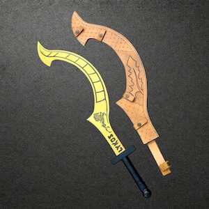 May include: A yellow curved blade with a black handle and the text LYKOS printed on the blade, accompanied by a tan leather sheath featuring a decorative leaf pattern, metal studs, and adjustable straps with metal buckles for secure fastening.