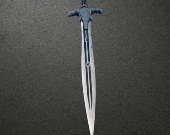 May include: A silver-toned sword featuring a dark, textured handle and a crossguard shaped like a stylized animal head. The blade is long and pointed, decorated with a central black stripe and two circular symbols etched along the vertical axis.