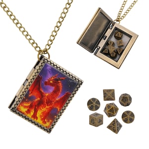 May include: A bronze-toned metal locket necklace shaped like a book, featuring a vibrant red dragon illustration on the cover. The locket opens to reveal a storage compartment for seven small, metallic polyhedral dice, which are also shown separately.