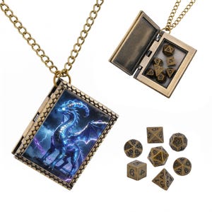 May include: A bronze-toned metal locket necklace shaped like a book, featuring a blue dragon illustration on the cover. The locket opens to reveal a set of miniature polyhedral dice. Seven additional bronze-toned metal dice are displayed separately.
