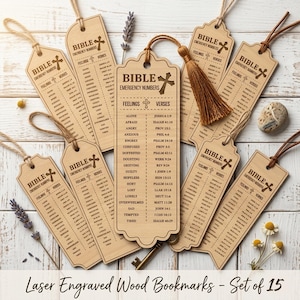 May include: Set of 15 laser-engraved wooden bookmarks. Each bookmark features the text "BIBLE EMERGENCY NUMBERS" and a list of feelings with corresponding Bible verses. The bookmarks are light brown with a natural wood grain.