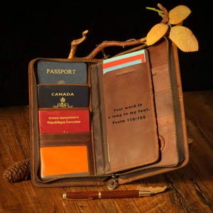 May include: A white ceramic mug with a black handle and the text "But First, Coffee" in a black, handwritten-style font. The mug is on a white surface.