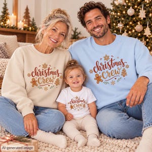 May include: A beige sweatshirt, a light blue sweatshirt, and a white t-shirt, each featuring the text "christmas crew" in brown script, surrounded by graphic illustrations of gingerbread people, stars, and snowflakes.