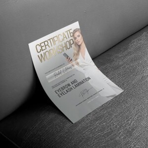 May include: A certificate with gold lettering that reads "CERTIFICATE WORKSHOP" and "EYEBROW AND EYELASH LAMINATION". The certificate is awarded to Rachel Lang. A woman in a white dress is pictured on the certificate.