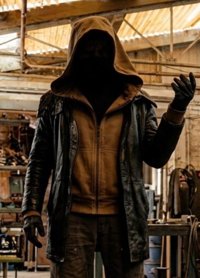 May include: A hooded jacket ensemble featuring a tan zip-up hoodie layered beneath a black leather coat. The outfit includes dark trousers and black gloves. The hood is pulled up, obscuring the face, while the jacket features a structured collar.