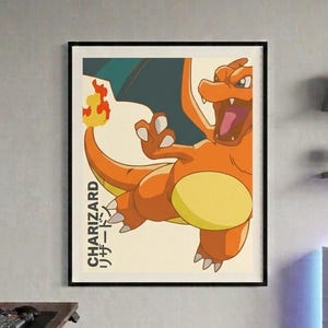 May include: A framed poster featuring Charizard, an orange and yellow dragon-like creature. The artwork has a vintage style with Japanese text and a black frame. The background is a light beige color.