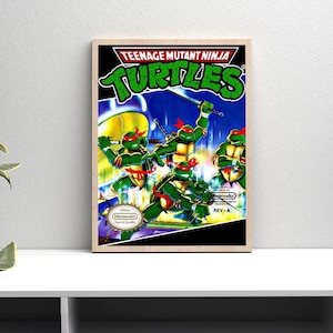 May include: Framed print of the Teenage Mutant Ninja Turtles video game cover art. The artwork shows the four turtles in action poses with weapons, set against a green and blue background. The title is in bold, green letters.