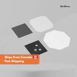 May include: An overhead view displays various geometric forms. Two white, multi-sided shapes, two black squares, and a black square with three holes are visible. The text "50x50mm" is in the upper right corner.