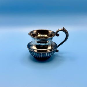 May include: A rustic wooden sign with the text "Welcome to our home" in white lettering. The sign has a distressed finish and a simple, inviting design, ideal for entryway decor.