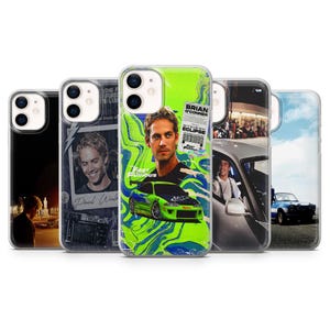 May include: A collection of five phone cases featuring images from the Fast & Furious movie franchise. The cases display images of Paul Walker, cars, and movie scenes. The cases are in various colors, including black, white, and green.