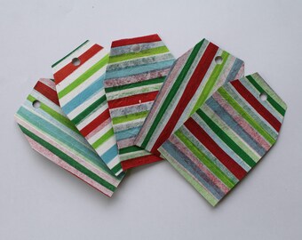 May include: A selection of striped gift tags in various colours including red, green, blue, and white. Each tag has a small hole at the top for attaching to a gift. The tags are arranged in a fan shape, ideal for presents and special occasions.