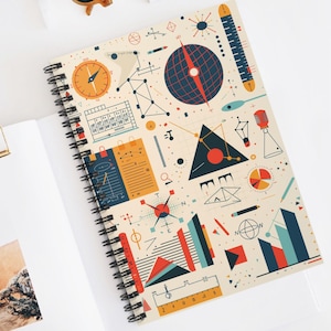 May include: Spiral-bound notebook with a cream cover, featuring a geometric design in orange, blue, and red. The design includes compasses, triangles, and scientific elements. The notebook is open on a white surface.