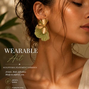 May include: Gold-toned and green sculptural statement earrings. The earrings feature a gold flower design atop a green, leaf-like shape. The image includes the text "WEARABLE Art" and "SCULPTURAL STATEMENT EARRINGS".